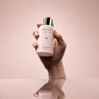 Hand holding XIVORA ISH Eau De Parfum bottle